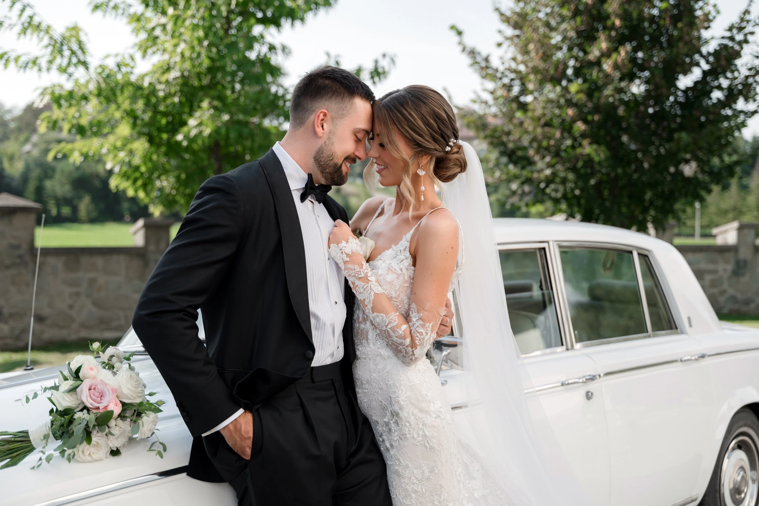 The newlyweds kissing in front of firecrackers