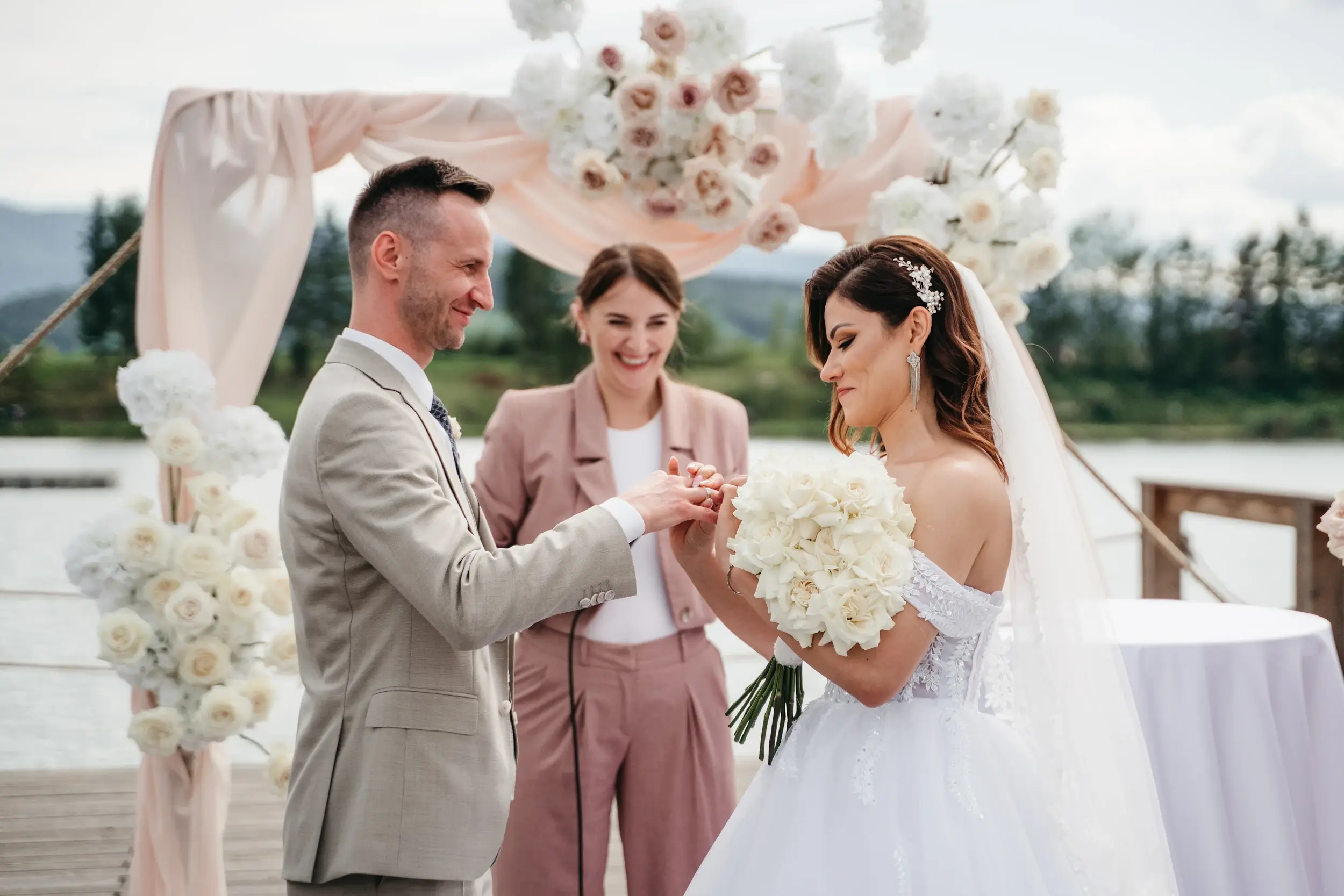 The newlyweds kissing in front of guests